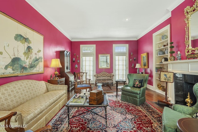 1616 Poplar Blvd, Jackson, MS 39202 - living room with a fireplace with flush hearth, wood finished floors, built in features, ornamental molding, and baseboards