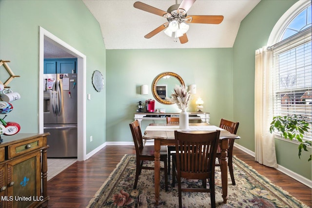 dining room with lofted ceiling, ceiling fan, baseboards, and wood finished floors