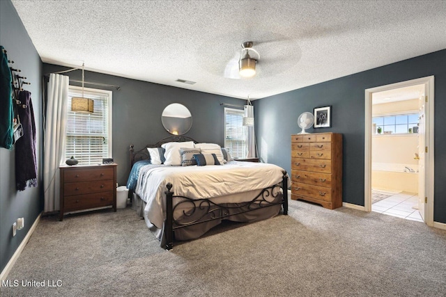 bedroom with baseboards, visible vents, a ceiling fan, a textured ceiling, and carpet floors