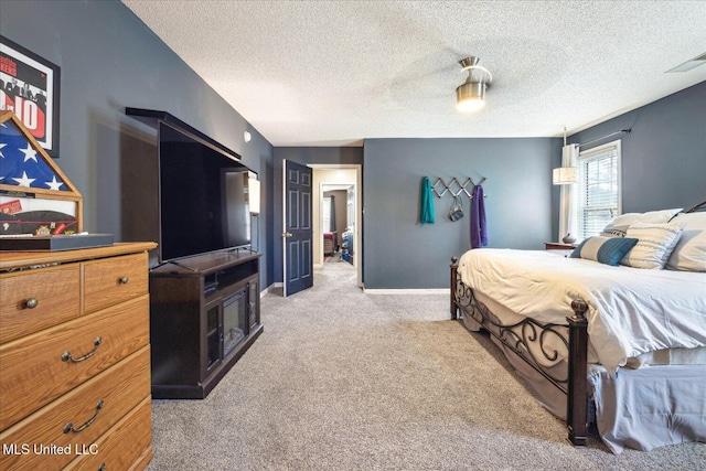 bedroom featuring baseboards, a textured ceiling, visible vents, and light colored carpet