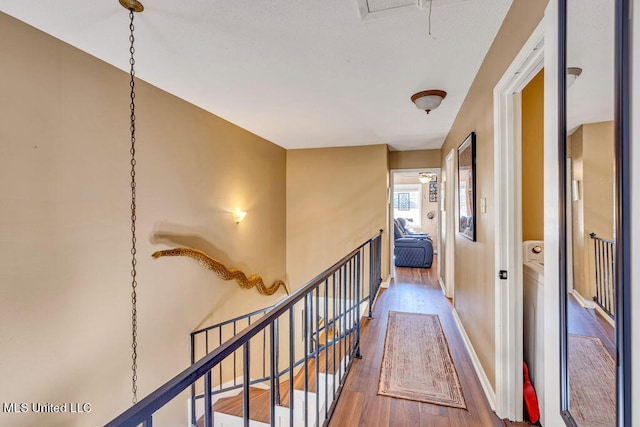 corridor with hardwood / wood-style floors