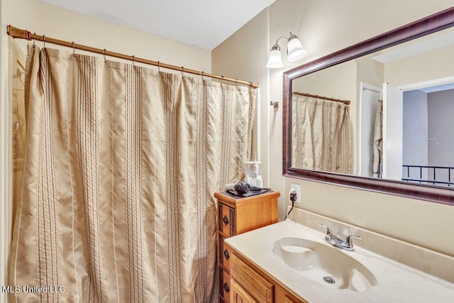 bathroom featuring vanity and a textured ceiling