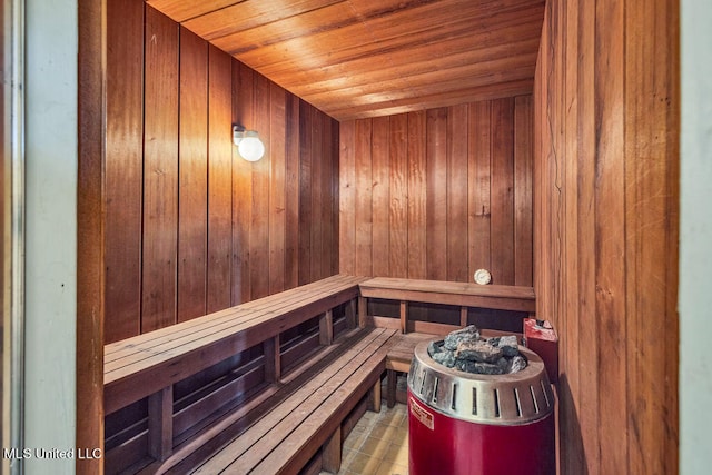 view of sauna featuring wooden ceiling and wooden walls