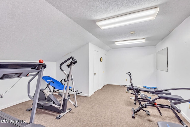 exercise area featuring a textured ceiling and light colored carpet