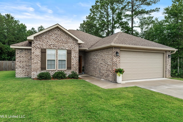 67 E Andover, Hattiesburg, MS 39402 - ranch-style house featuring brick siding, an attached garage, roof with shingles, and concrete driveway