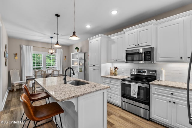 67 E Andover, Hattiesburg, MS 39402 - kitchen with stainless steel appliances, backsplash, white cabinetry, a kitchen island with sink, and recessed lighting