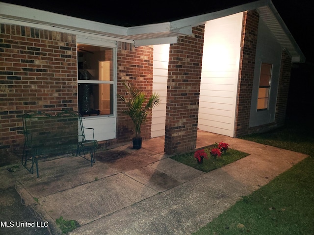 entrance to property featuring a patio