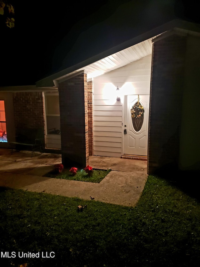 view of exterior entry at night