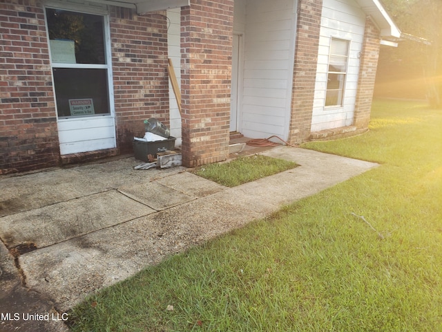 doorway to property with a lawn