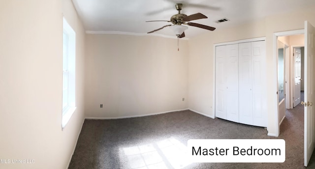 unfurnished bedroom with carpet floors, a closet, and ceiling fan