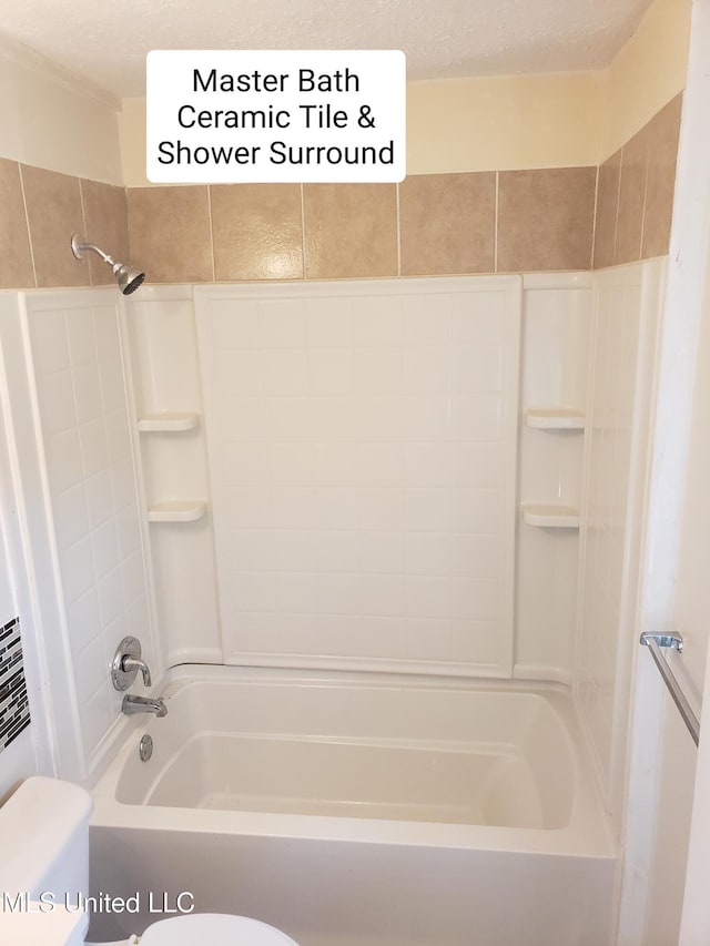 bathroom featuring a textured ceiling, tiled shower / bath combo, and toilet