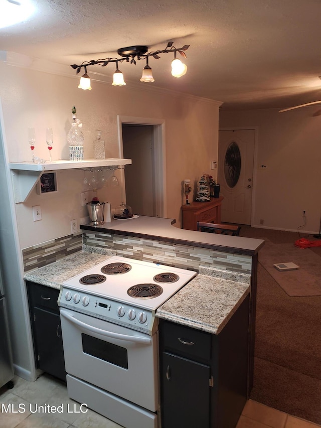 kitchen with decorative backsplash, light tile patterned floors, kitchen peninsula, and white range with electric stovetop