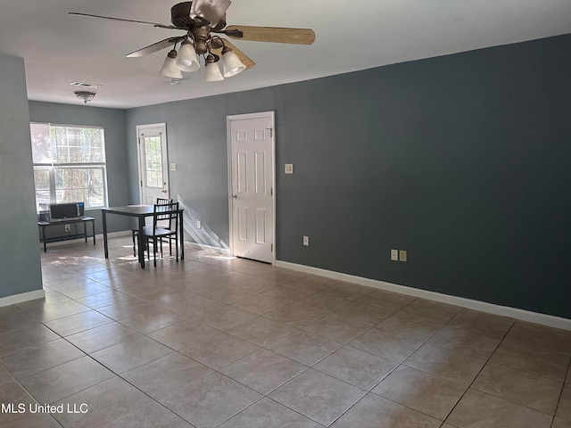 unfurnished room featuring ceiling fan and light tile patterned floors