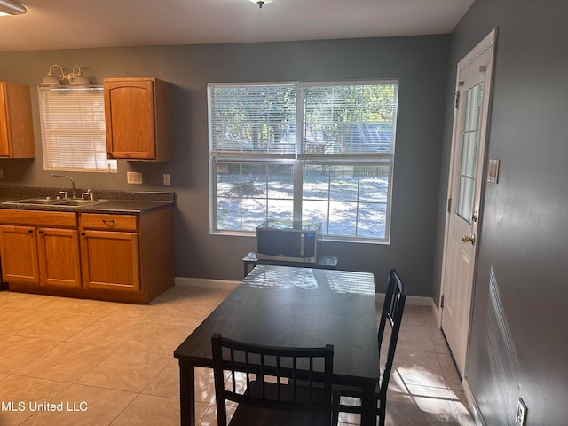 kitchen with a healthy amount of sunlight, light tile patterned floors, and sink