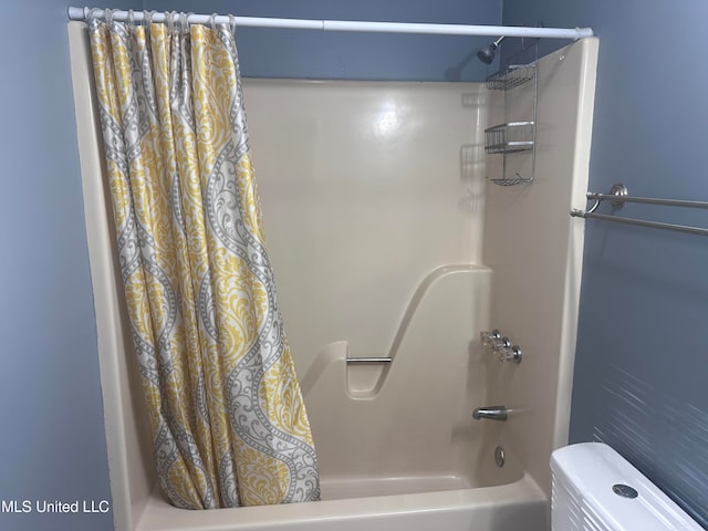 bathroom with toilet and shower / bath combo with shower curtain