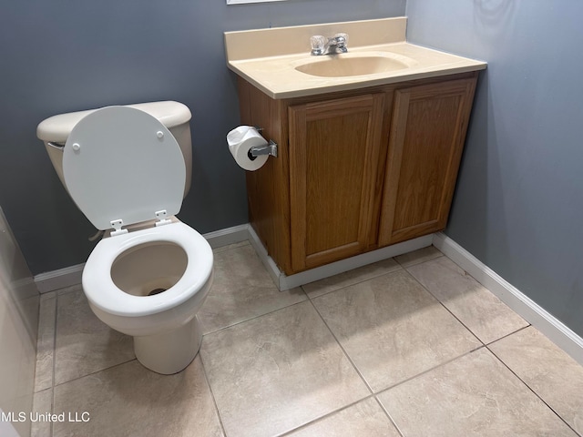 bathroom featuring tile patterned floors, vanity, and toilet