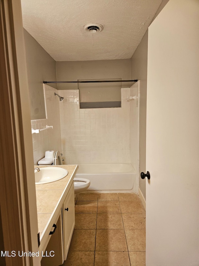 bathroom featuring visible vents, toilet, a textured ceiling, vanity, and tile patterned flooring