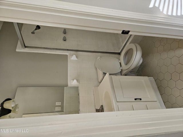 bathroom featuring washer / clothes dryer and toilet