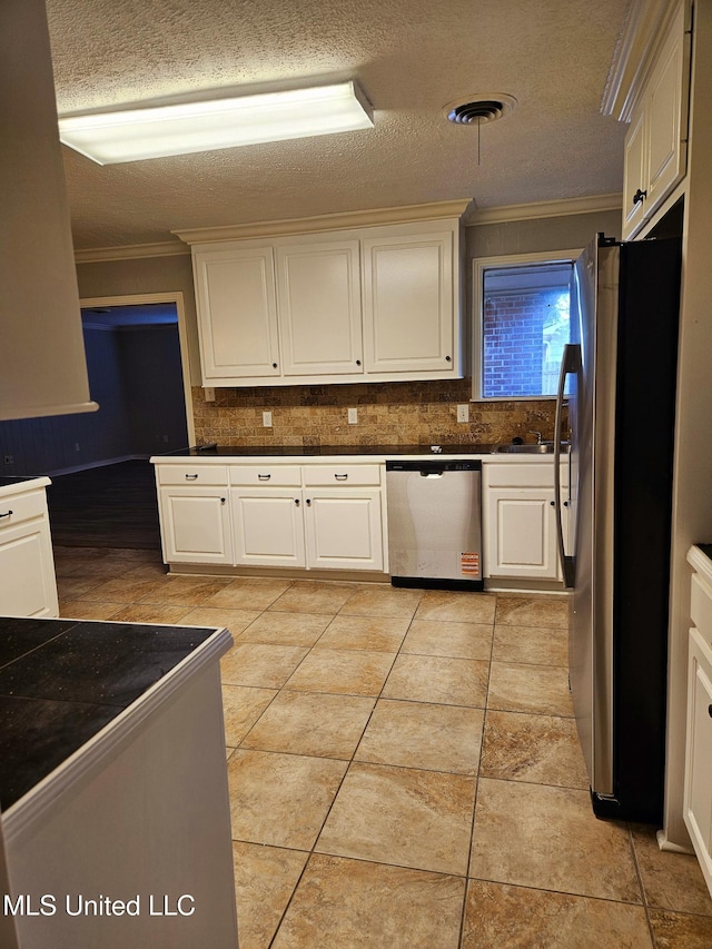 kitchen featuring stainless steel appliances, tasteful backsplash, visible vents, and crown molding