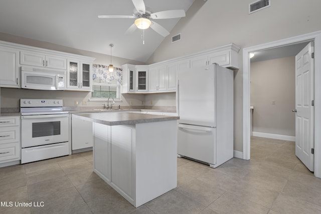 kitchen featuring glass insert cabinets, white cabinets, visible vents, and white appliances
