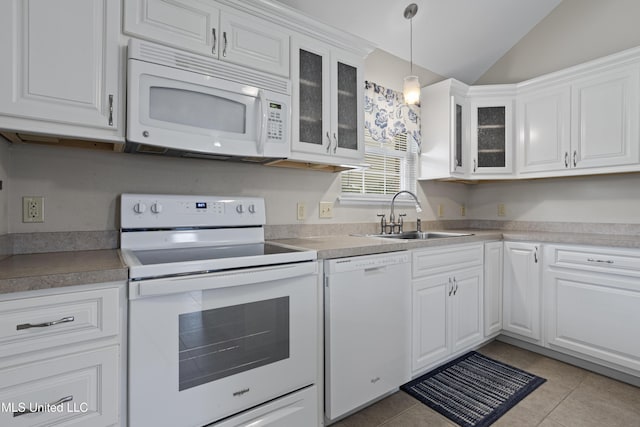 kitchen with white cabinetry, light tile patterned floors, a sink, and white appliances