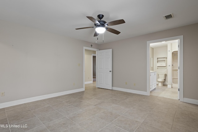 unfurnished bedroom featuring light tile patterned floors, baseboards, connected bathroom, visible vents, and a ceiling fan