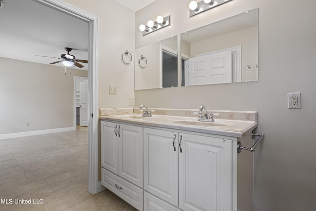 bathroom featuring double vanity, ceiling fan, a sink, and tile patterned flooring