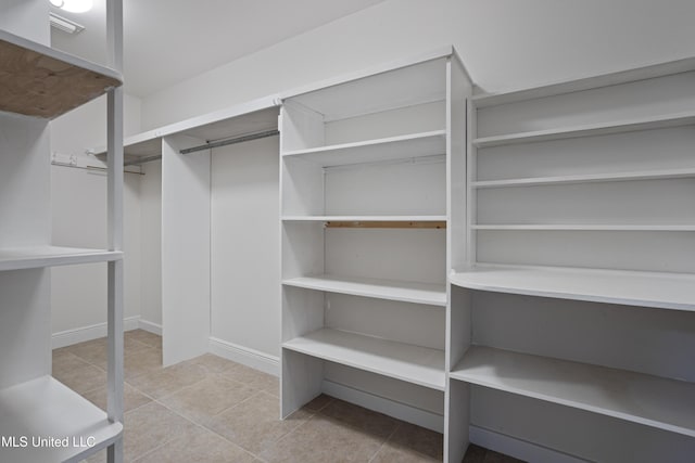 spacious closet featuring tile patterned floors