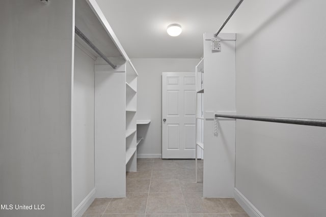 walk in closet featuring light tile patterned flooring