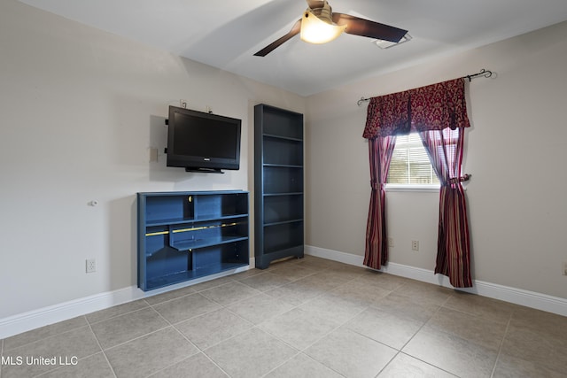 unfurnished living room with baseboards, ceiling fan, and light tile patterned floors