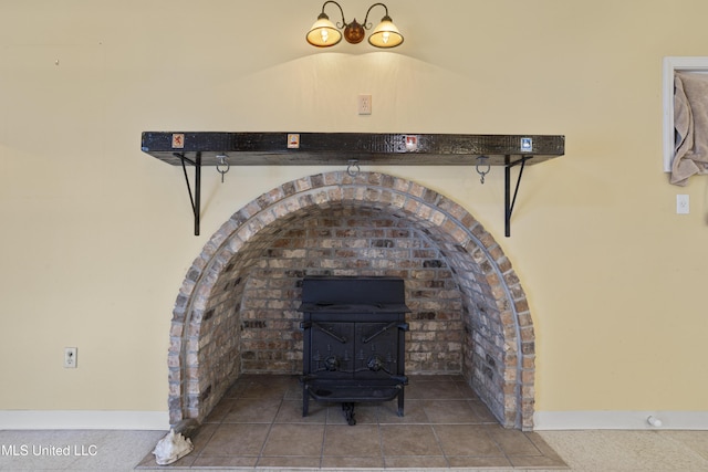 room details featuring baseboards and a wood stove