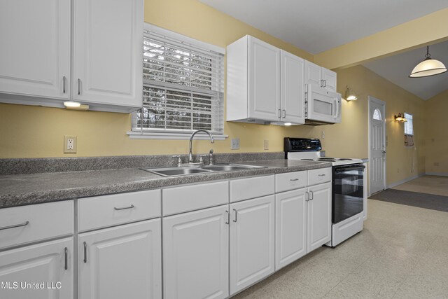 kitchen with a wealth of natural light, a sink, white cabinetry, white appliances, and dark countertops