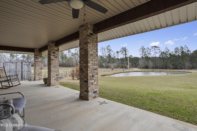 view of patio with a ceiling fan and a water view
