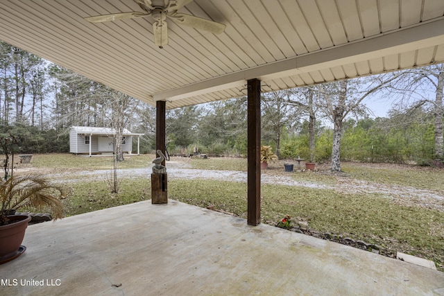 view of patio / terrace with an outbuilding and ceiling fan
