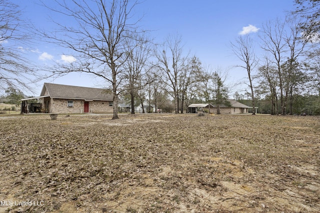 view of yard featuring an attached carport