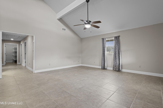 unfurnished room with visible vents, baseboards, attic access, and ceiling fan