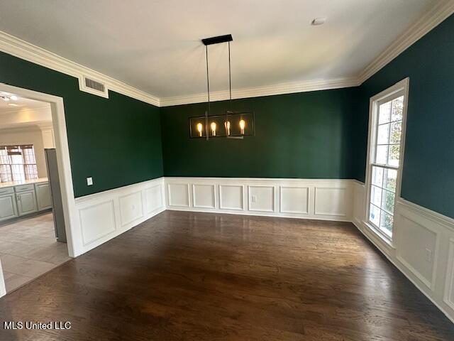 117 Peninsula Dr, Brandon, MS 39047 - unfurnished dining area featuring wainscoting, visible vents, crown molding, and wood finished floors