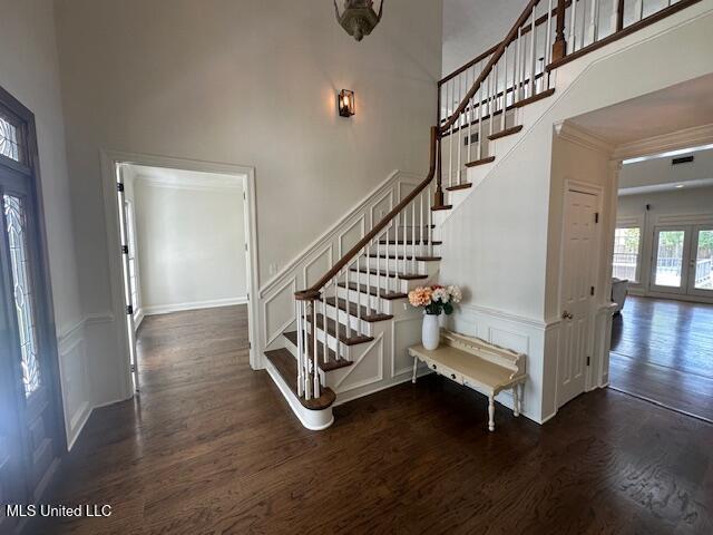 117 Peninsula Dr, Brandon, MS 39047 - staircase with a high ceiling, a decorative wall, visible vents, and wood finished floors