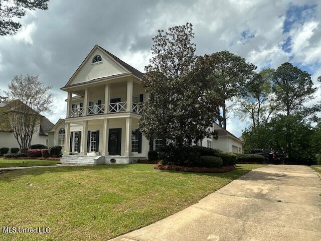 117 Peninsula Dr, Brandon, MS 39047 - greek revival house with a balcony and a front yard