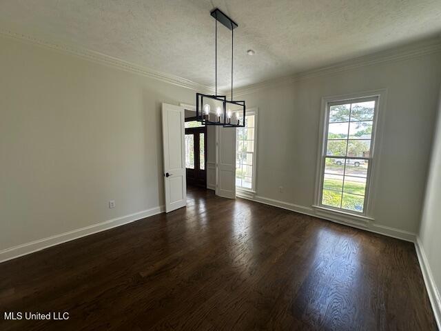 117 Peninsula Dr, Brandon, MS 39047 - unfurnished dining area with a notable chandelier, crown molding, a textured ceiling, baseboards, and dark wood-type flooring