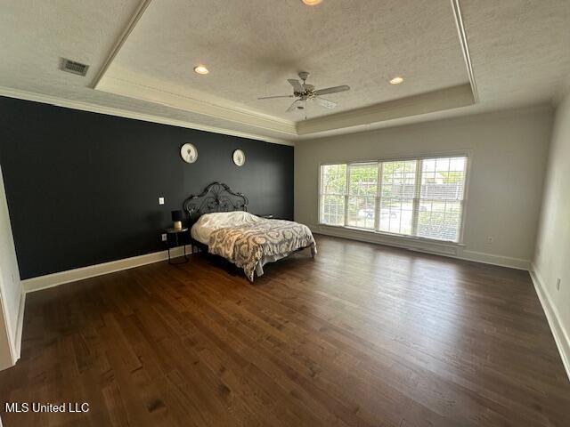 117 Peninsula Dr, Brandon, MS 39047 - bedroom with baseboards, a textured ceiling, and a raised ceiling
