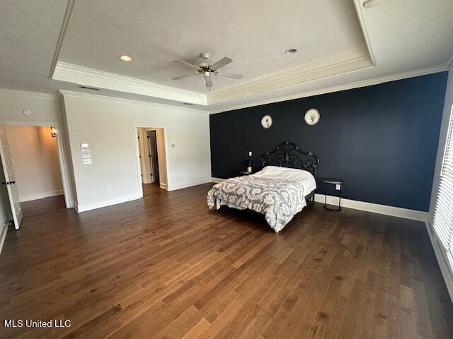 117 Peninsula Dr, Brandon, MS 39047 - bedroom featuring visible vents, crown molding, baseboards, wood finished floors, and a raised ceiling