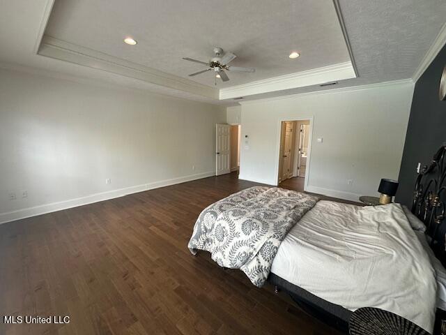 117 Peninsula Dr, Brandon, MS 39047 - bedroom with baseboards, a tray ceiling, wood finished floors, and ornamental molding