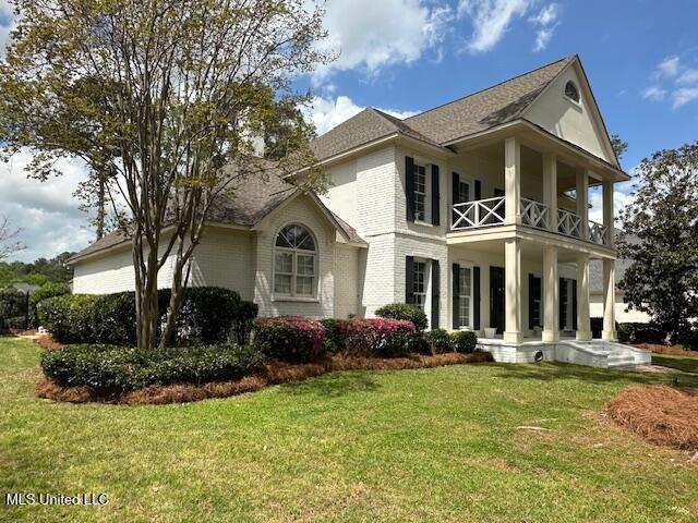 117 Peninsula Dr, Brandon, MS 39047 - exterior space featuring a balcony, brick siding, a lawn, and roof with shingles