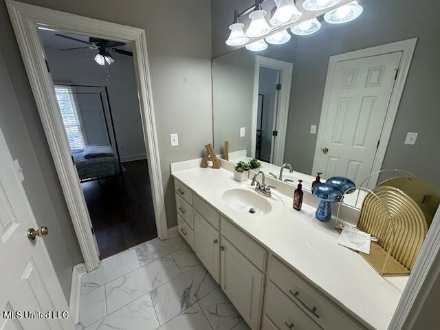 117 Peninsula Dr, Brandon, MS 39047 - bathroom with marble finish floor, baseboards, ceiling fan, and vanity