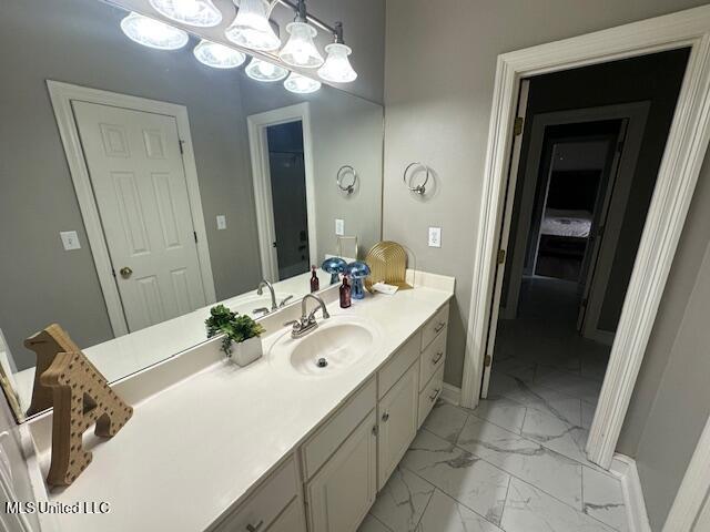 117 Peninsula Dr, Brandon, MS 39047 - bathroom featuring marble finish floor, baseboards, vanity, and a chandelier