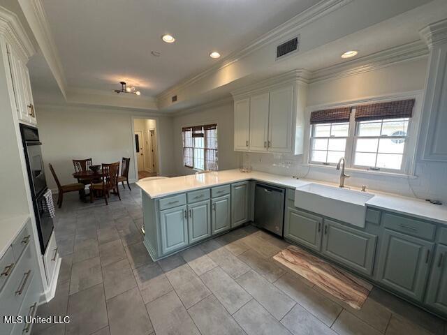 117 Peninsula Dr, Brandon, MS 39047 - kitchen featuring visible vents, a peninsula, a sink, dishwashing machine, and a tray ceiling
