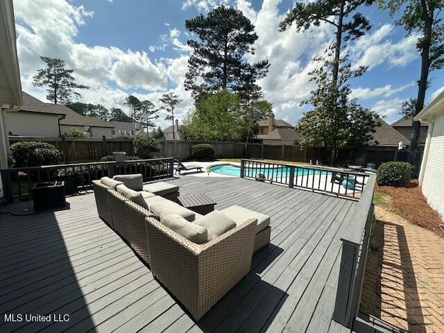 117 Peninsula Dr, Brandon, MS 39047 - deck featuring outdoor lounge area, a fenced in pool, and a fenced backyard