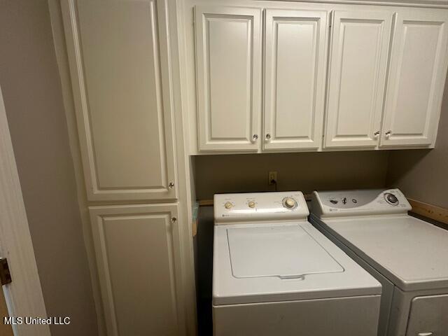 117 Peninsula Dr, Brandon, MS 39047 - clothes washing area featuring separate washer and dryer and cabinet space