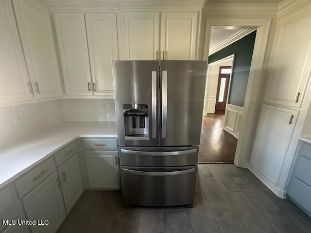 117 Peninsula Dr, Brandon, MS 39047 - kitchen featuring white cabinetry, light countertops, a decorative wall, and stainless steel fridge with ice dispenser